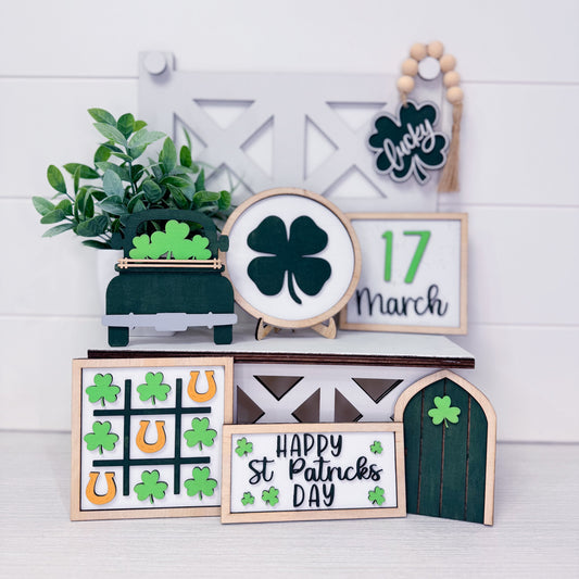 Decorative items with St. Patrick's Day theme on a white wooden background
