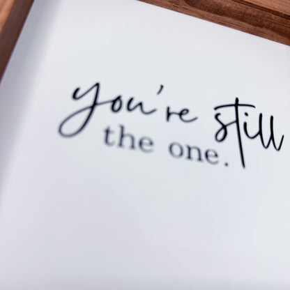 Note with 'you're still the one' text in a wooden frame