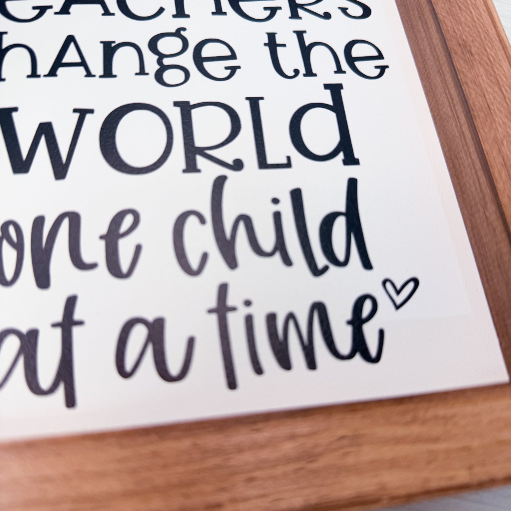 Motivational quote on a framed poster with wooden border