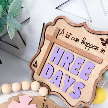 Wooden sign with 'A lot can happen in THREE DAYS' text on a light background