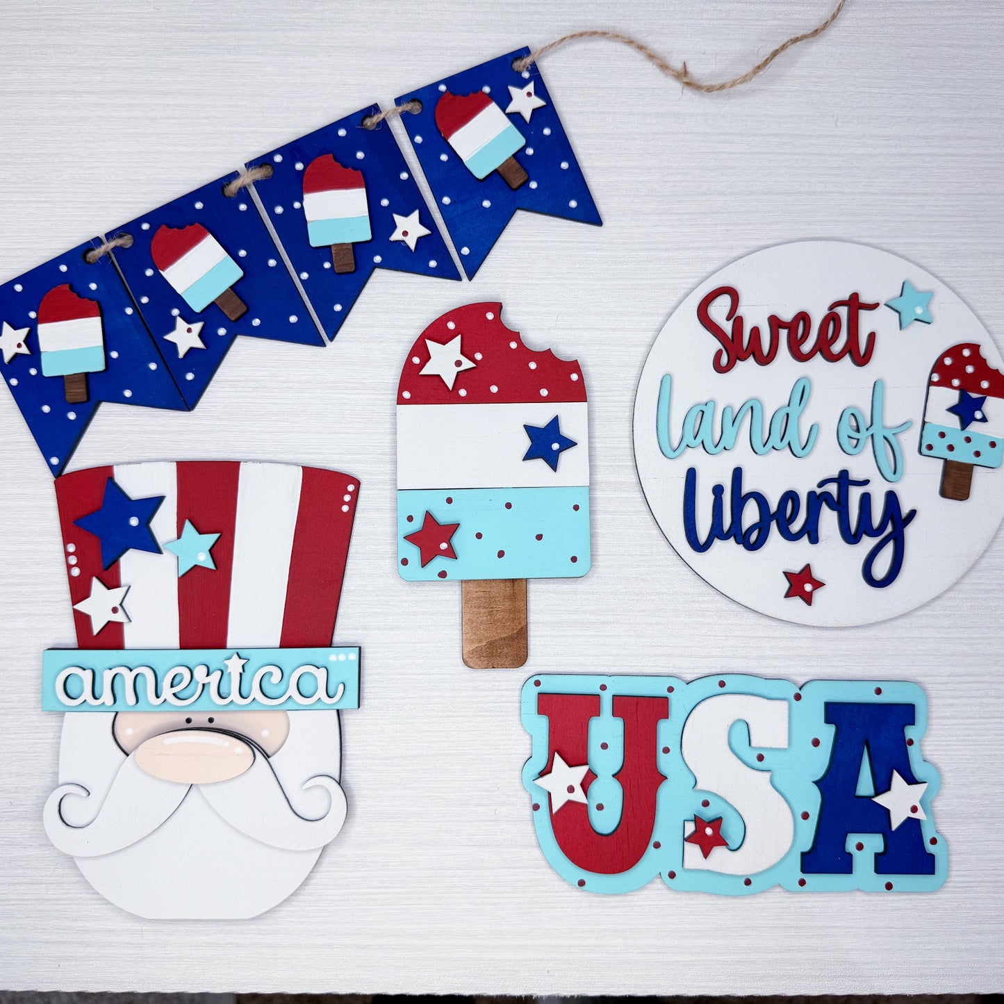 Decorative set with 'Sweet Land of Liberty', 'USA', and other patriotic-themed items on a white background.