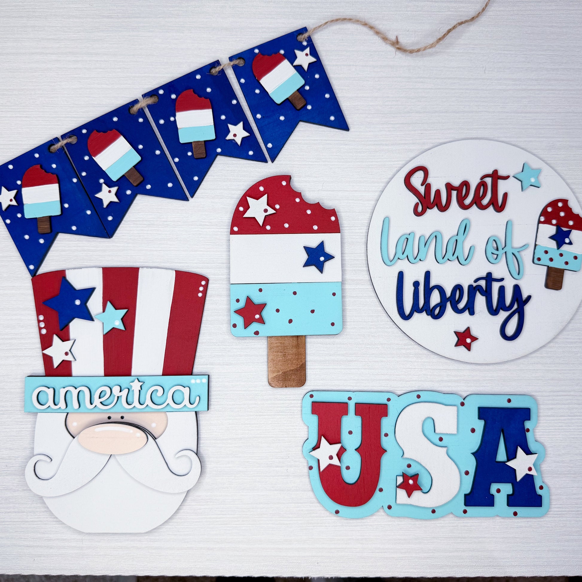 Decorative set with 'Sweet Land of Liberty', 'USA', and other patriotic-themed items on a white background.
