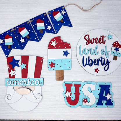 Decorative set with 'Sweet Land of Liberty', 'USA', and other patriotic-themed items on a white background.