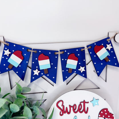 Decorative banner with ice cream cone and star designs on a white background