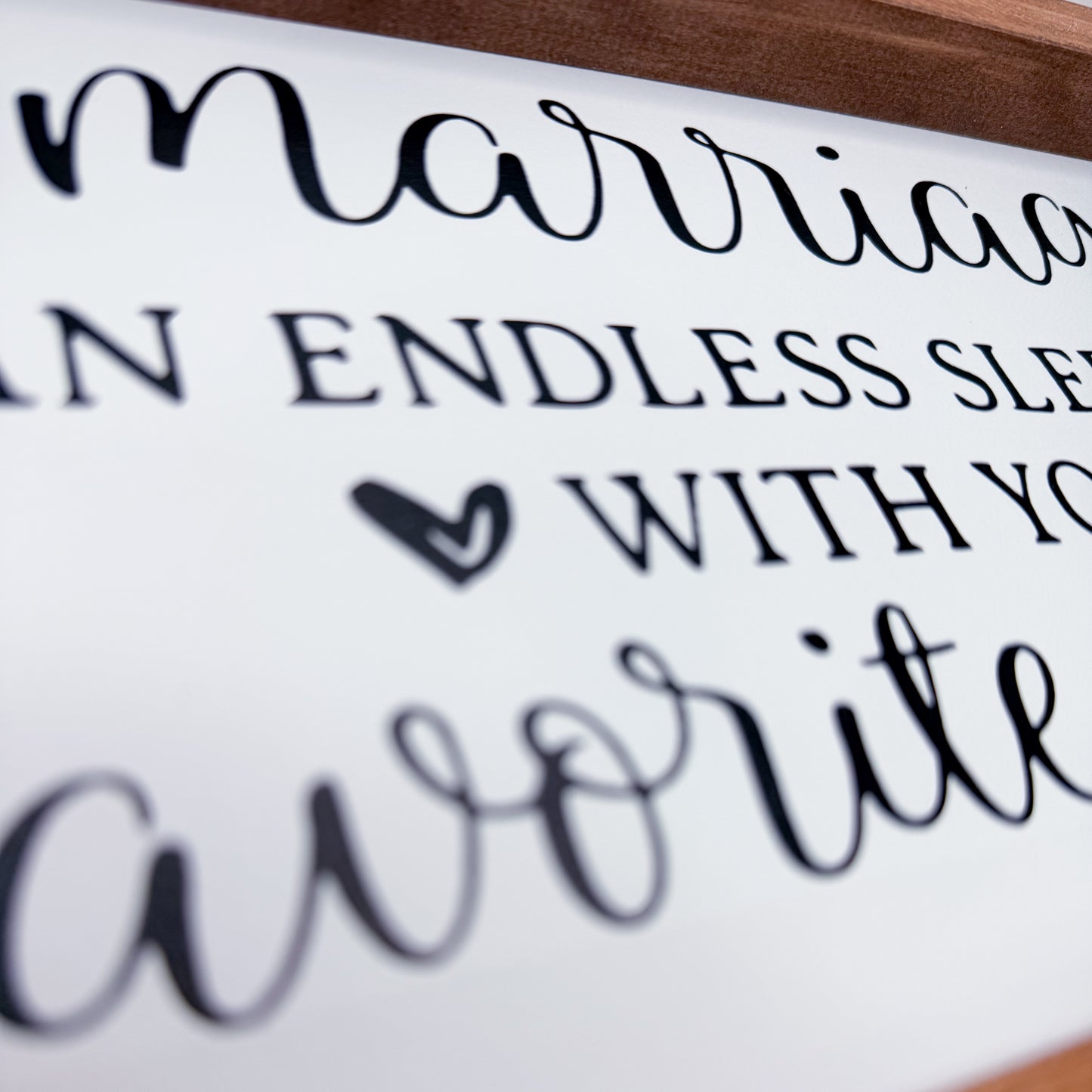 Framed sign with cursive text on a white background