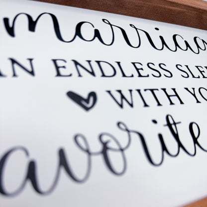 Framed sign with cursive text on a white background