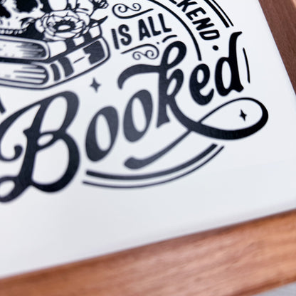 Decorative sign with 'BooKed' text on a white background