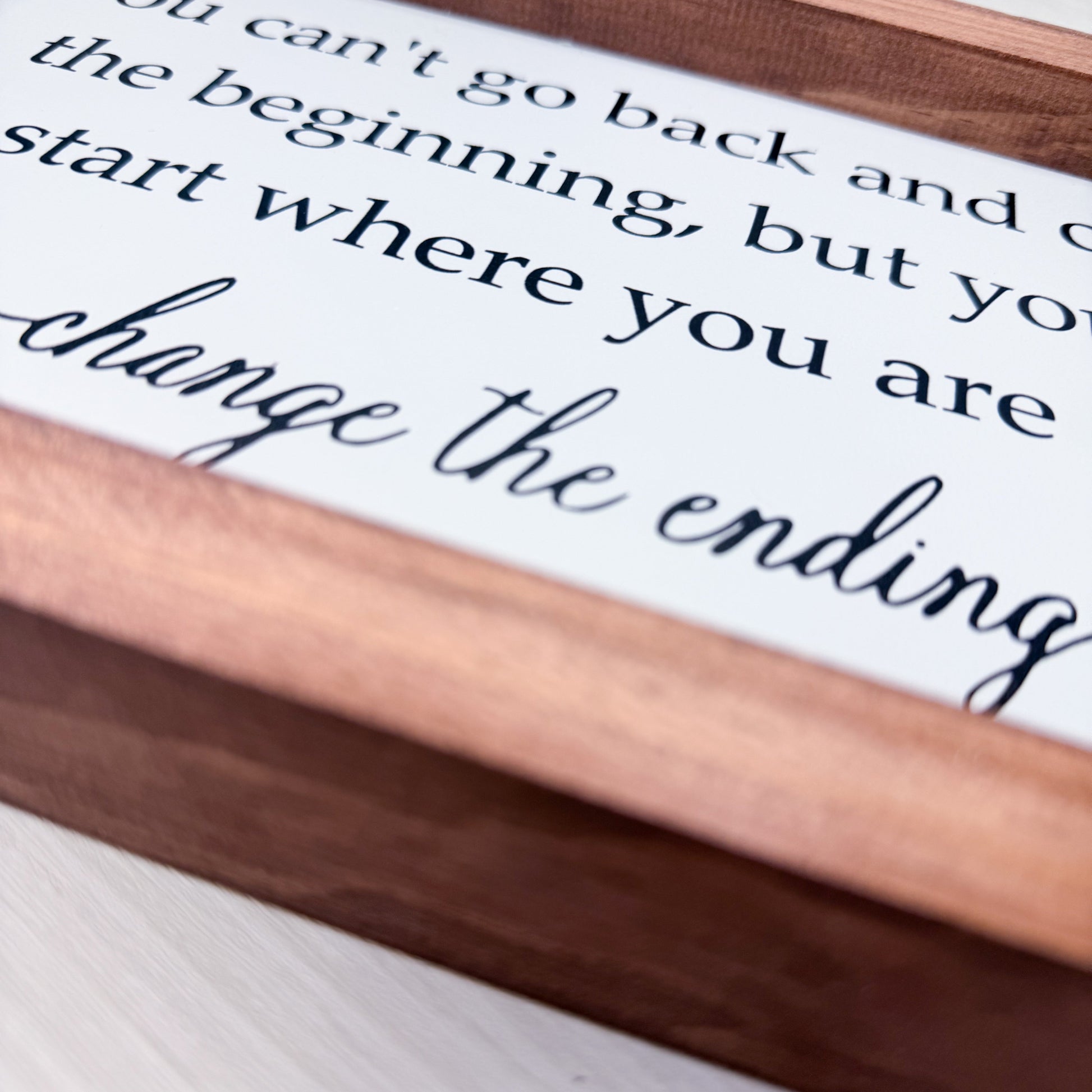 Wooden sign with motivational quote on a white background